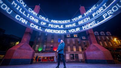 A woman views 'Together' by Lucid Creates on Wednesday evening. The art installation from the communities of Aberdeen, Scotland, is on display in the city's Castlegate, as part of the Spectra festival. PA