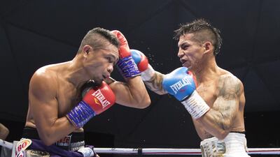 Donnie Nietes of the Philippines on a defensive move with Pablo Carillo of Colombia at the Rotunda, Ceasar's Palace, Bluewaters Island, Dubai. Leslie Pableo for The National