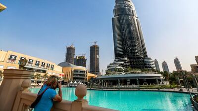 A tourist takes a photo of the burned Address Downtown hotel in Dubai. Victor Besa for The National