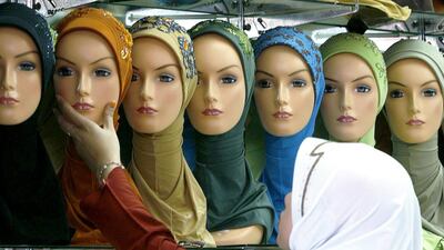 A woman selects a hijab at an outdoor market. Why does this piece of cloth anger people so much? (Reuters/Beawiharta)