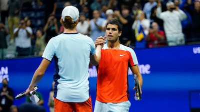 Carlos Alcaraz shakes hands with Jannik Sinner at the end of their US Open quarterfinal match. AP