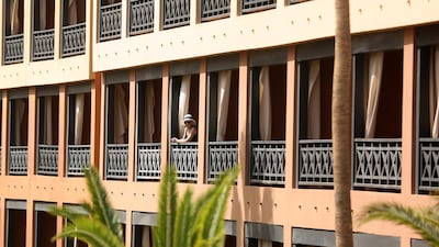 A tourist looks on from her balcony at a hotel that was put in quarantine due to a coronavirus infection, in Adeje, Tenerife, Spain. EPA