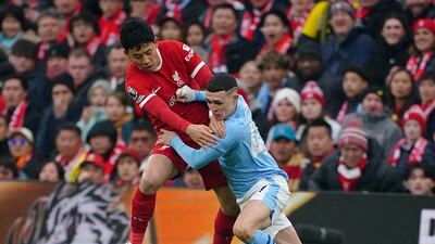 Liverpool's Wataru Endo and Manchester City's Phil Foden battle. PA