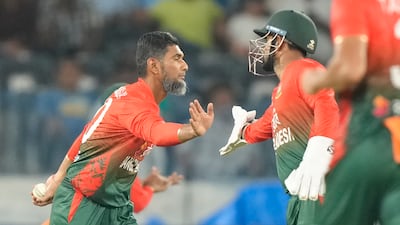Bangladesh's Mohammad Mahmudullah, left, celebrates with Litton Das after taking the wicket of India's captain Suryakumar Yadav. It was Mahmudullah's final T20I after a record number of 20-over appearances for his country. AP