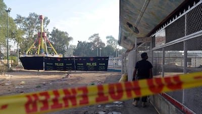 A Pakistani police commando stands guard at site of the Easter Sunday suicide bombing in a Lahore park. Arif Ali / AFP Photo