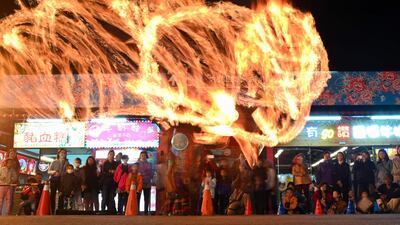 A slow-shutter speed exposure shows trails from a performing fire dancer during a ceremony at the Taoist Jian temple to mark the 230th anniversary of the temple's founding, in Shulin District in New Taipei City. AFP