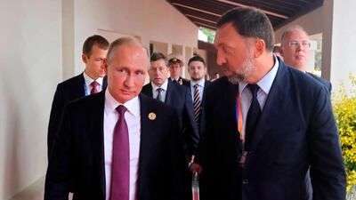 Russia's President Vladimir Putin, left, and Russian metals magnate Oleg Deripaska, right, walking to attend the APEC Business Advisory Council dialogue in Danang, Vietnam. Mikhail Klimentyev, Sputnik, Kremlin Pool Photo via AP