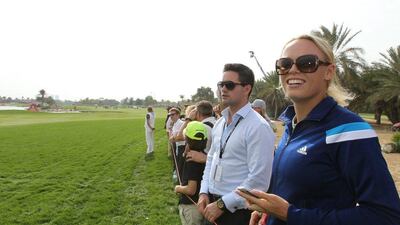 Caroline Wozniacki watches husband Rory McIlroy on Sunday. McIlroy finished the tournament with a 13-under 275. Ali Haider / EPA