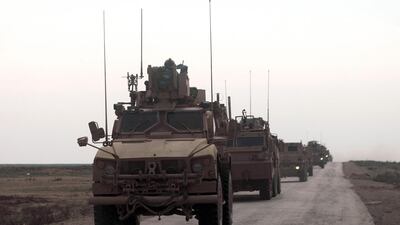 US military vehicles drive in a convoy with local allies in eastern Syria on February 21. AFP