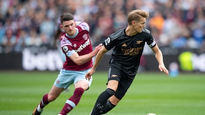 Martin Odegaard of Arsenal holds off Declan Rice of West Ham United. Getty Images