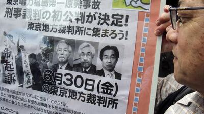A poster showing the three executives now on trial for alleged negligence over the Fukushima nuclear disaster of 2011. The trial began in Tokyo district court on June 30,2017. Koji Sasahara / AP