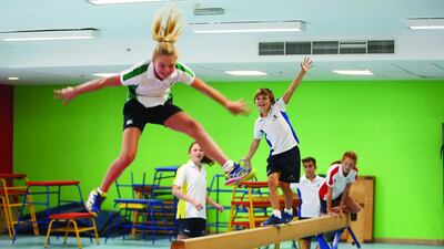 Year 7 pupils enjoy gymnastics during a PE class at Brighton College Abu Dhabi. Pawan Singh / The National