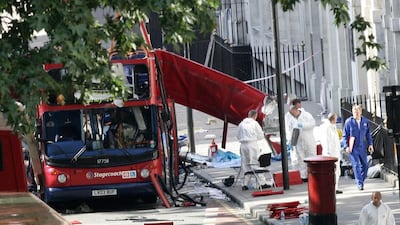 Forensic investigators examine the remains of a London bus bombed on July 7, 2005. Without an ability to criticise foreign policies, the West cannot win the war of ideas among extremists, writes Faisal Al Yafai (AFP PHOTO/PACO SERINELLI)