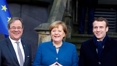 Armin Laschet, federal premier of Germany's North Rhine-Westphalia (left), German Chancellor Angela Merkel (centre) and French President Emmanuel Macron (right) attend a signing of a new agreement on bilateral cooperation and integration, known as Treaty of Aachen, in Aachen, Germany, January 22, 2019. REUTERS