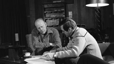 President Gerald Ford and presidential assistant Donald Rumsfeld huddle over bills in Vail, Colorado, in December 1974. The president was spending a working holiday at the ski resort with his family. AP Photo