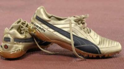 The shoes worn by Jamaica's Usain Bolt placed on the ground after his team won the men's relay final.