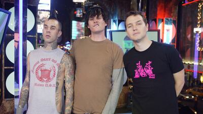 From left, Travis Barker, Tom DeLonge and Mark Hoppus on MTV's 'Total Request Live' at the MTV Times Square Studios in November 2003 in New York City. Getty