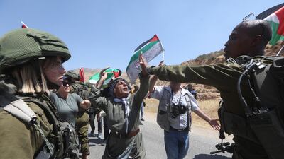 Israeli soldiers argue with Palestinians at Tayasee checkpoint, near the West Bank city of Tubas, on Monday. EPA