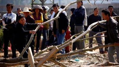 Residents reinforce a barricade made of trees laid across a street at the village of Wukan in Lufeng county, Guangdong province. David Gray / Reuters