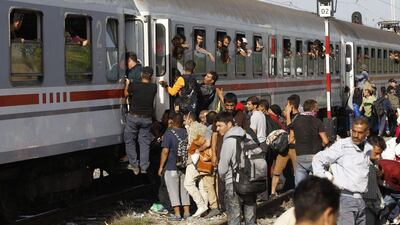 Migrants try to board a train in Tovarnik, Croatia. The train left Friday morning carrying hundreds to refugee centres in the capital Zagreb and elsewhere. Petr David Josek / AP Photo