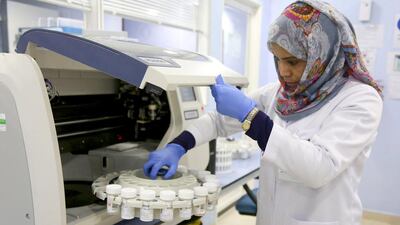 A laboratory technician at work in the histopathology unit of Al Borg Medical Laboratories in Abu Dhabi, where up to 5,000 tests a day are conducted. Irene García León for The National