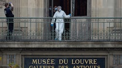 A French forensics officer examines the cut window and balcony of a gallery at the Louvre following a robbery last October. Getty Images