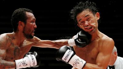 Japanese champion Shinsuke Yamanaka, right, is punched by the challenger, Anselmo Moreno of Panama, during their WBC bantamweight title match in Tokyo. Toru Takahashi / AP Photo