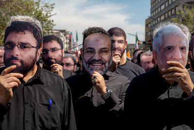 Iranians wear masks of the seven slain IRGC members killed by an Israeli strike on the Iranian embassy in Syria. Getty