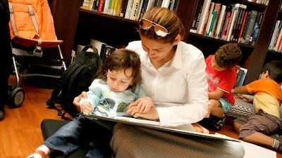 A mother reads a book to her child at Sharjah Art Museum. Photo Sharjah Art Museum