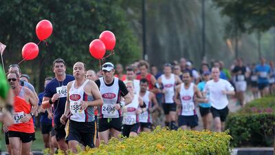 About 2,000 runners took part in the Dubai Half Marathon on Friday morning, taking in sights around Dubai Creek, Satish Kumar / The National