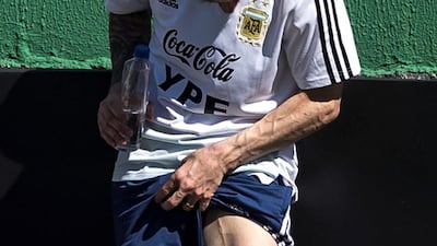 Argentina captain Lionel Messi examines his left leg on the sidelines of a training session EPA