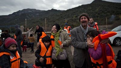 Yazidi refugee Samir Qasu, 45, right, from Sinjar, Iraq, and his wife Bessi, 42, cried and embraced their children in early December 2015, after arriving on the Greek island of Lesbos from Turkey. The island was the first port of EU call for nearly 400,000 asylum seekers in 2015. Muhammed Muheisen / Associated Press