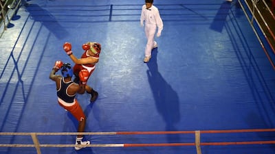 Fights swing at one another during a boxing round at India's National Chess Boxing Championship in Kolkata on Monday, showcasing the sport composed of six chess rounds and five boxing rounds. Dibyangshu Sarkar / AFP