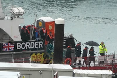Home Secretary Suella Braverman, 3rd right, during a visit to the migrant processing centre in Dover, Kent. PA