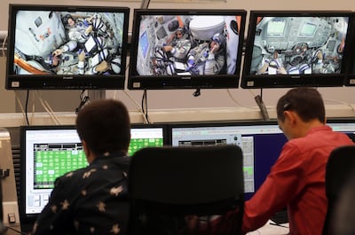 Hazza Al Mansouri, Roscosmos cosmonaut Oleg Skripochka and Nasa astronaut Jessica Meir are seen on screens during their final exams at the Russian cosmonaut training center in Star City outside Moscow. Maxim Shipenkov / EPA