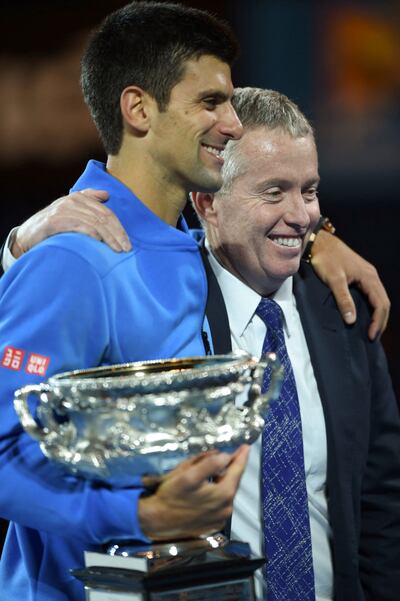 Serbia's Novak Djokovic (L) holding the Norman Brookes Trophy as he poses with tournament director Craig Tiley after his victory in the men's singles final against Britain's Andy Murray on day 14 of the 2015 Australian Open tennis tournament in Melbourne. AFP