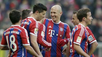 Bayern Munich's Arjen Robben, centre, celebrates with teammates after Franck Ribery scored his side's seventh goal during their German Bundesliga match against Hamburger in the Allianz Arena in Munich, Germany, Saturday, Feb. 14, 2015. (AP Photo/Matthias Schrader)