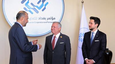 Iran's Foreign Minister Hossein Amirabdollahian (L) speaking to King Abdullah (C) as Crown Prince Hussein bin Abdullah looks on in Sweimeh. AFP