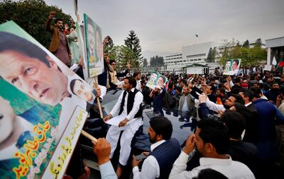 Supporters of Pakistan's ruling party Tehreek-e-Insaf gather outside parliament in Islamabad to celebrate Prime Minister Imran Khan winning a vote of confidence on March 6, 2021. AP Photo
