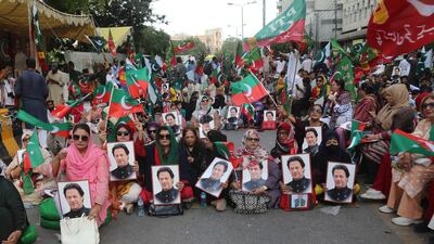 Supporters of Pakistan Tehreek-e-Insaf display portraits of Imran Khan at a protest in Karachi last month to demand his release from prison. EPA