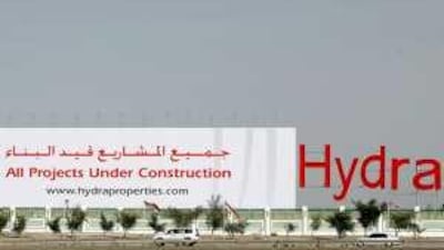 A large advertisement for Hydra Village Abu Dhabi, on the edge of the construction site facing highway 11 on the way to Dubai.