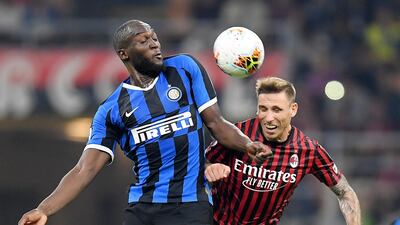 Inter Milan's Romelu Lukaku in action with AC Milan's Lucas Biglia. Reuters