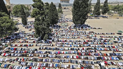 Palestinian worshippers praying near the Dome of the Rock in Jerusalem's Al Aqsa Mosque compound last year. AFP