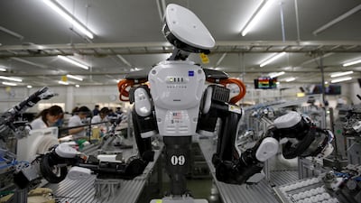 A humanoid robot works side by side with employees in the assembly line at a factory of Glory, a manufacturer of automatic change dispensers, in Kazo, north of Tokyo, Japan, in 2015. Reuters