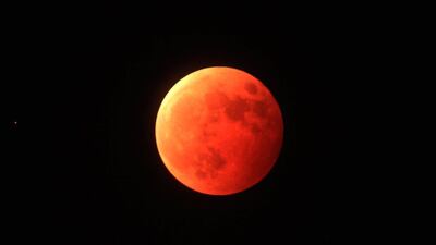 A blood moon from the total lunar eclipse is seen in the sky in Qingdao city, Shandong province, eastern China, last October.