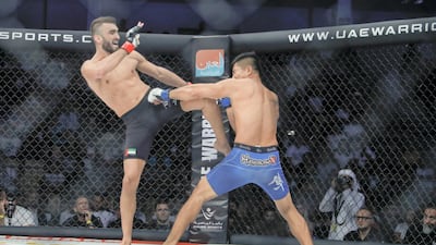 Mohammed Yahya lands a kick on Glenn Ranillo on his way to victory in their lightweight bout. Victor Besa/The National
