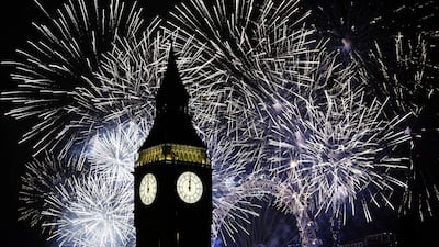 Fireworks illuminate the Elizabeth Tower, part of the Houses of Parliament, and the London Eye in central London during New Year celebrations, on January 1, 2023. PA via AP