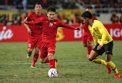 Vietnam's Nguyen Quang Hai, left, in action against Malaysia's Syazwan Andik during the AFF Suzuki Cup final on December 15. AFP