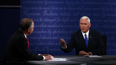 Mike Pence, the Republican vice presidential nominee, right, speaks as Tim Kaine, the Democratic vice presidential nominee, listens during the 2016 vice presidential debate at Longwood University in Farmville, Virginia, on October 4, 2016. Andrew Harrer/Bloomberg