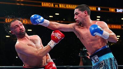 Danny Garcia, right, lands a punch against Paulie Malignaggi during their welterweight bout at Barclays Center on August 1, 2015 in Brooklyn borough of New York City. Mike Stobe/Getty Images